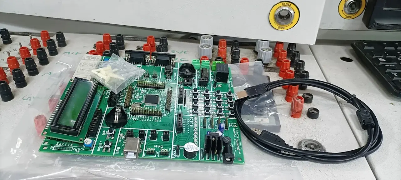 PIC microcontroller development board with LCD, CAN and USB on the workbench at the Technologics Global embedded lab